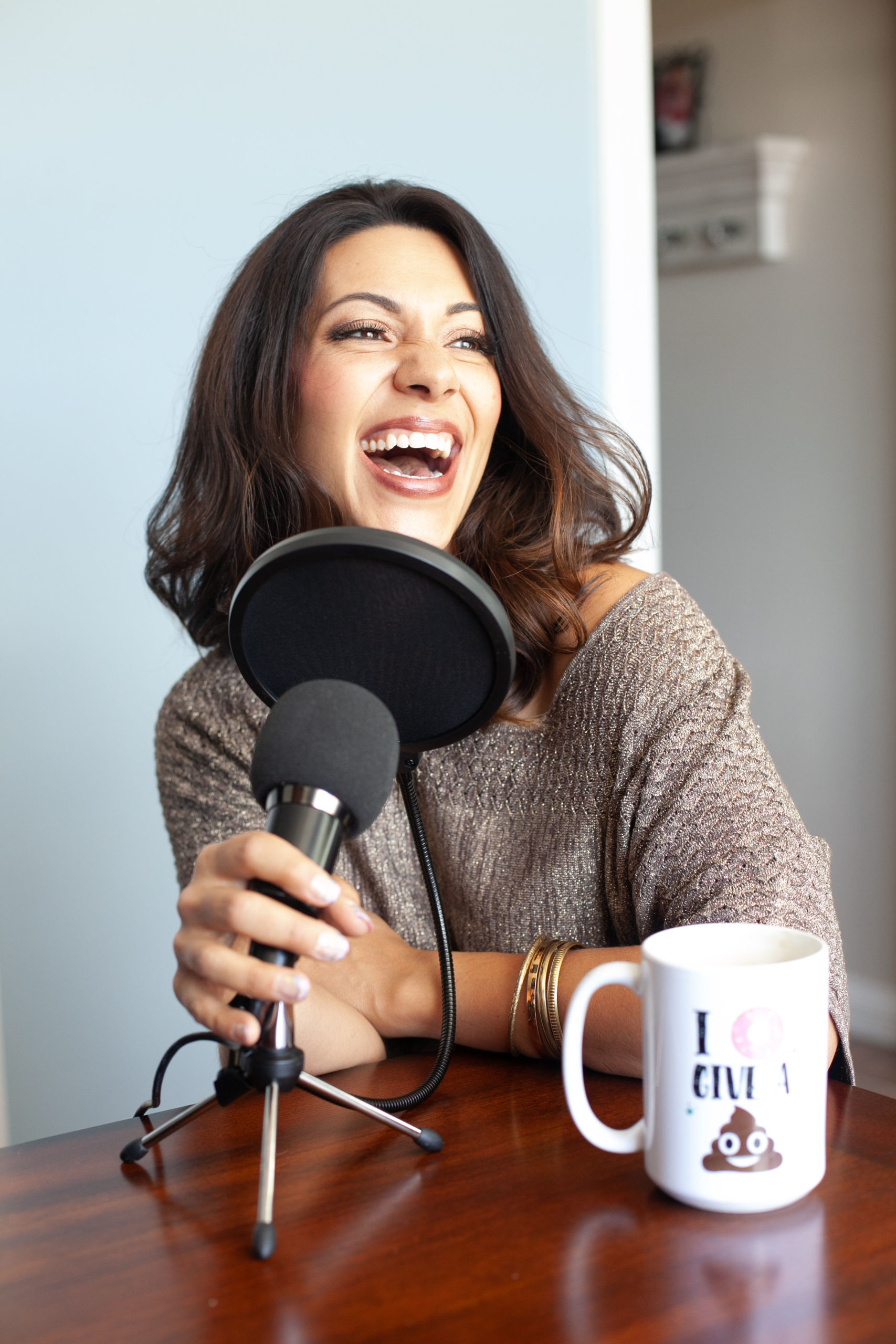 woman podcaster behind a mic