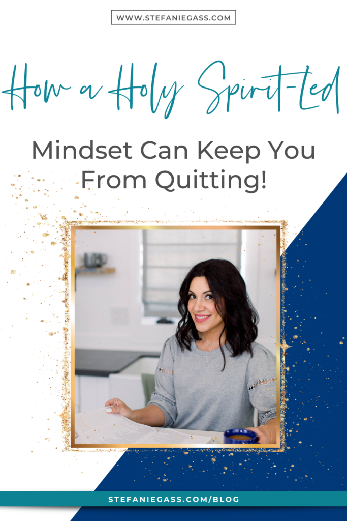 Navy blue and gold splatter frame with image of dark-haired woman sitting at desk with coffee cup and notebook and title How a Holy Spirit-Led mindset can keep you from quitting! stefaniegass.com/blog