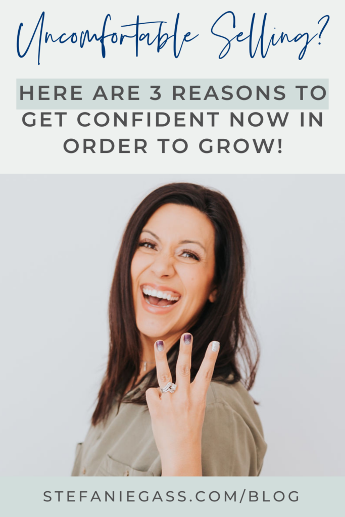 dark haired woman smiling at the camera. She's wearing a khaki blouse and holding her left up with three fingers displayed. The title says, "Uncomfortable selling? Here are 3 reasons to get confident now in order to grow!" Link at the bottom is stefaniegass.com/blog