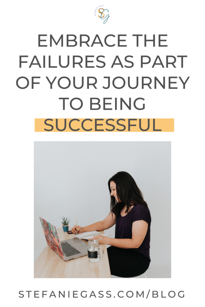 Photo of a dark haired woman sitting at her desk, working on her laptop, with text above reading Embrace the failures as part of your journey to being successful.