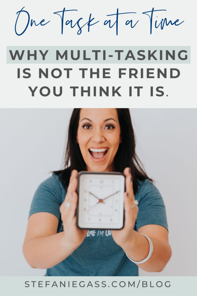 graphic with a title at the top that says, "One Task at a Time. Why Multi-tasking is not the Friend You Think it is." The image in the center is of a dark haired woman in a green shirt. She has a smile on her face and she's holding an alarm clock in front of her. The link at the bottom is stefaniegass.com/blog