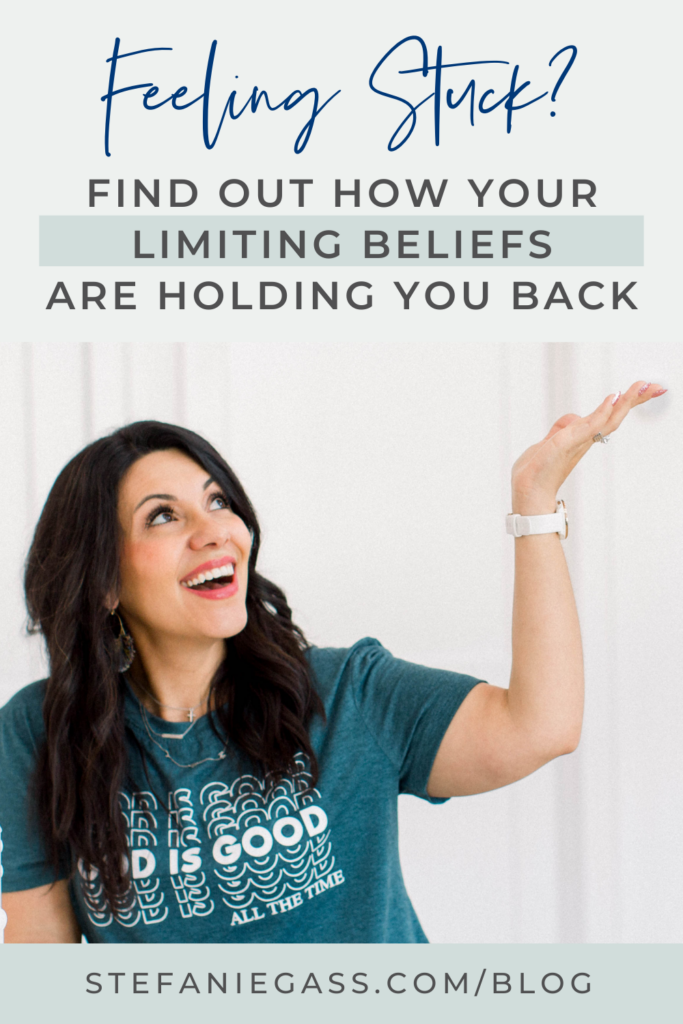 Title at the top says, "Feeling Stuck? Find Out How Your Limiting Beliefs Are Holding You Back." Image in the middle is of a dark haired woman wearing a green short that says, "God is Good. All the Time." Her left hand is raised toward the title and her eyes and smiling face are looking upward as well. Link at the bottom is stefaniegass.com/blog