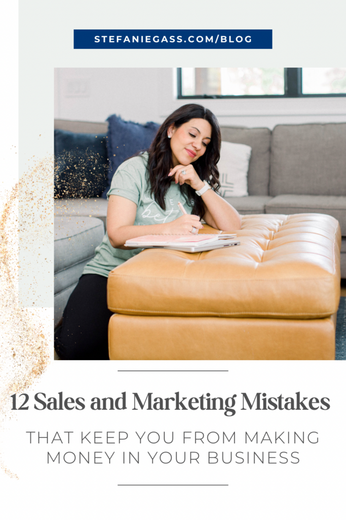 Dark haired lady sitting in floor in front of couch, writing on notepad laid on top of yellow-orange upholstered table. Chin propped on free hand. She is wearing a mint green shirt and dark pants. Title is 12 Sales and Marketing Mistakes Keeping You From Making Money in Your Business