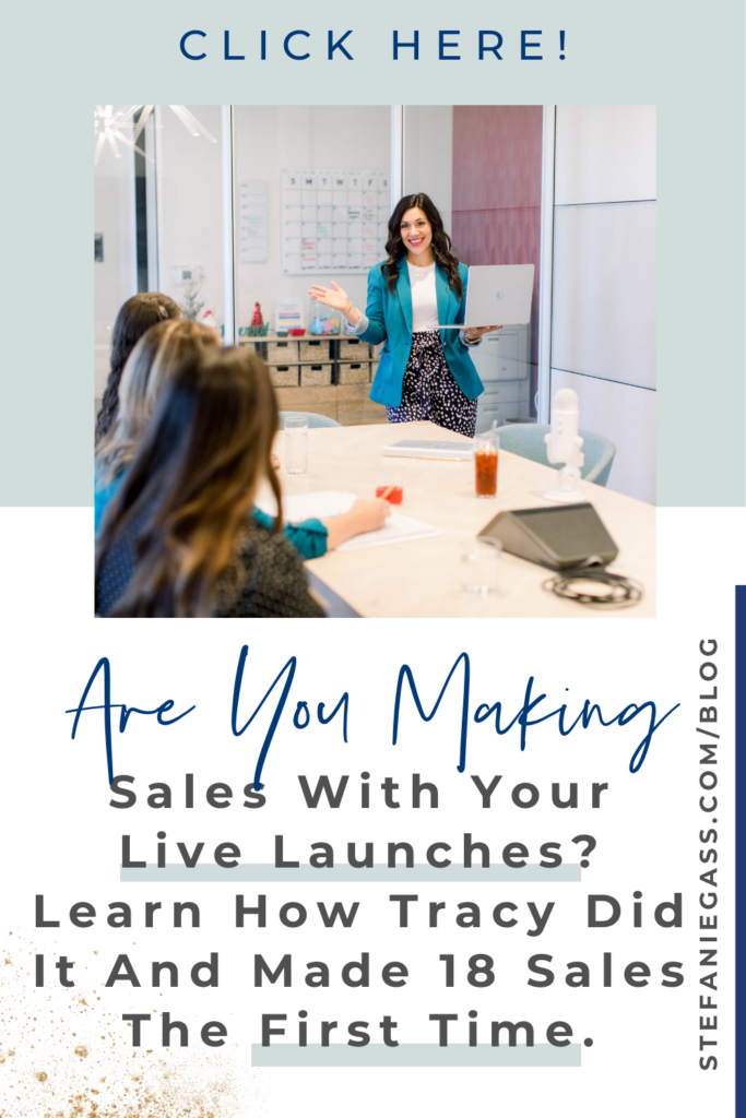 Brown haired woman talking to a group of women at a desk. She's holing a computer and wearing a blue blazer, white shirt and blue pants. Text says: Are you making sales with your live launches? Learn how Tracy did it and made 18 sales the first time. 