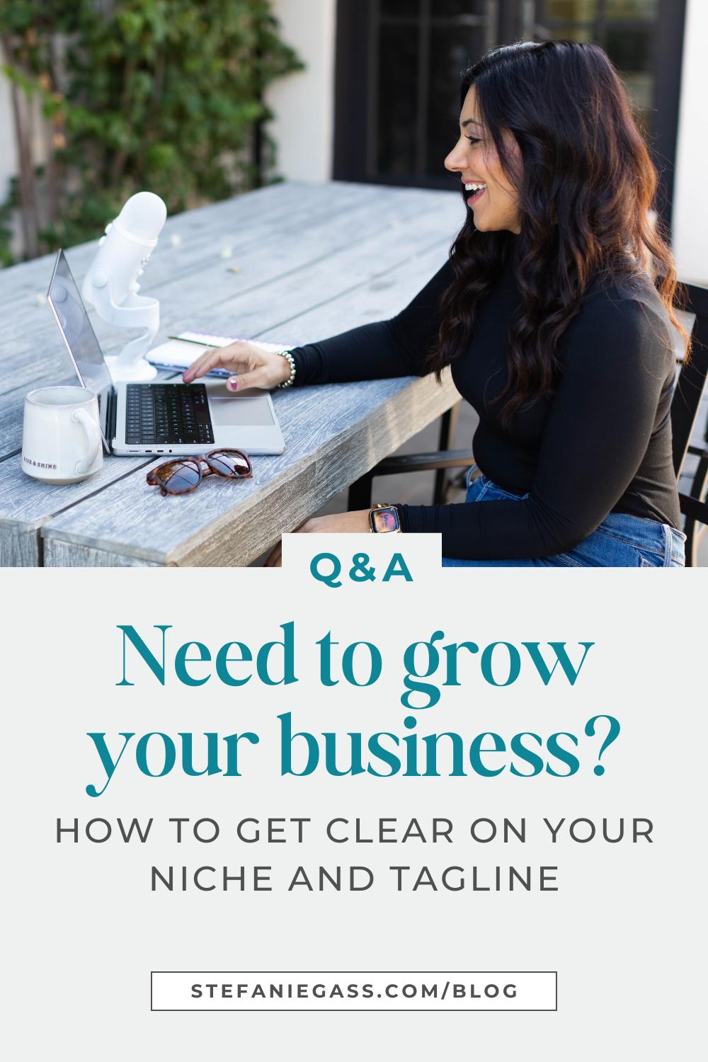 brown haired smiling woman sitting at a table with her laptop, podcast microphone, and sunglasses Text reads: Q&A Need to grow your business?  How to get clear on your niche and tagline, Stefanie Gass