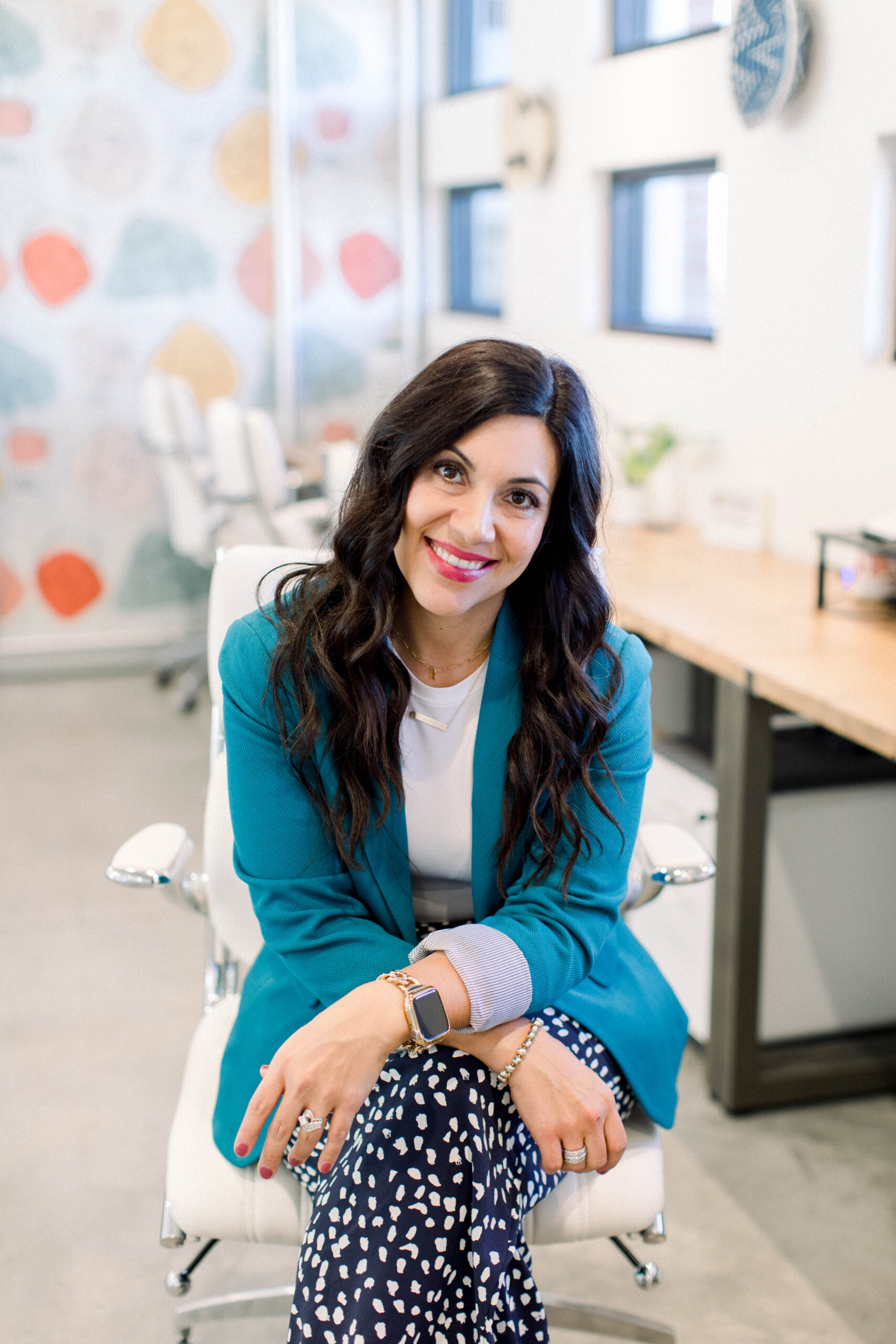 Image is a smiling woman with dark hair 