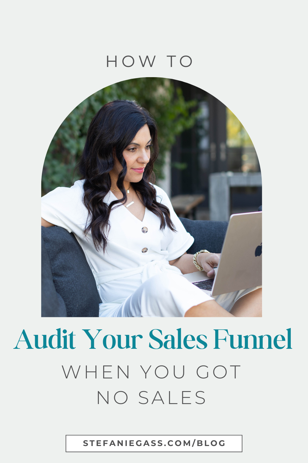 brown haired woman smiling as she looks at her laptop sitting in her lap.  She is sitting on a blue couch. Image text reads: How to Audit Your Sales Funnel When You Got No Sales, Stefanie Gass Blog