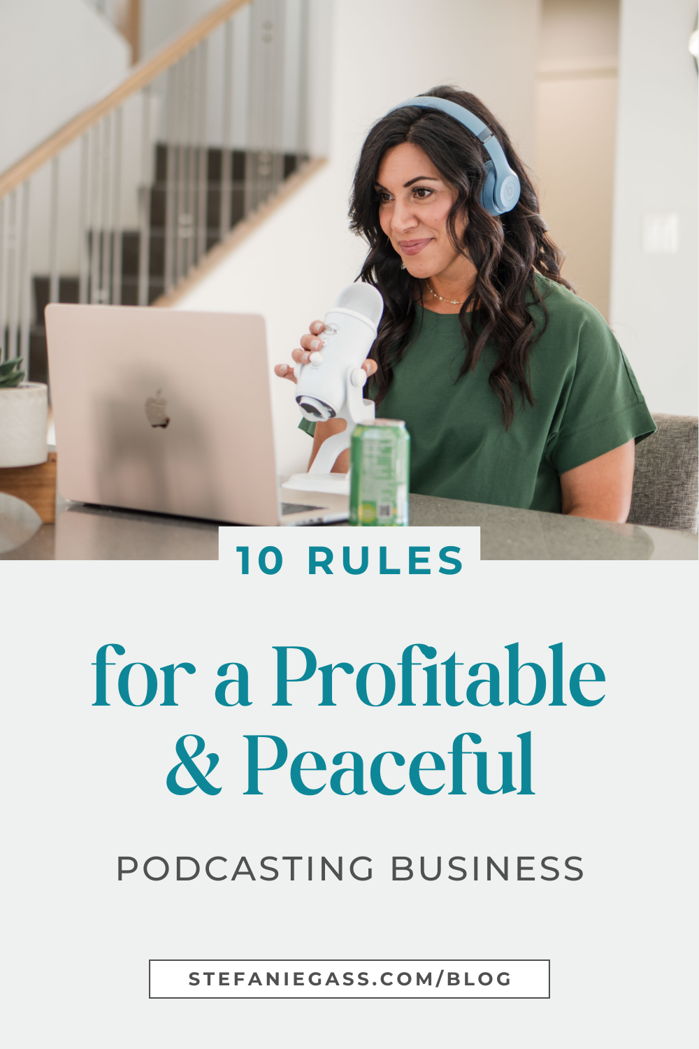 In this graphic, Stefanie Gass, a brunette with wavy hair, is sitting at a table looking at her laptop while holding a white microphone. She's also wearing blue headphones and a green t-shirt. The image title is: Ep-831-Ten-Rules-for-a-Profitable-and-Peaceful-Podcasting-Business-Stefanie-Gass-Branded