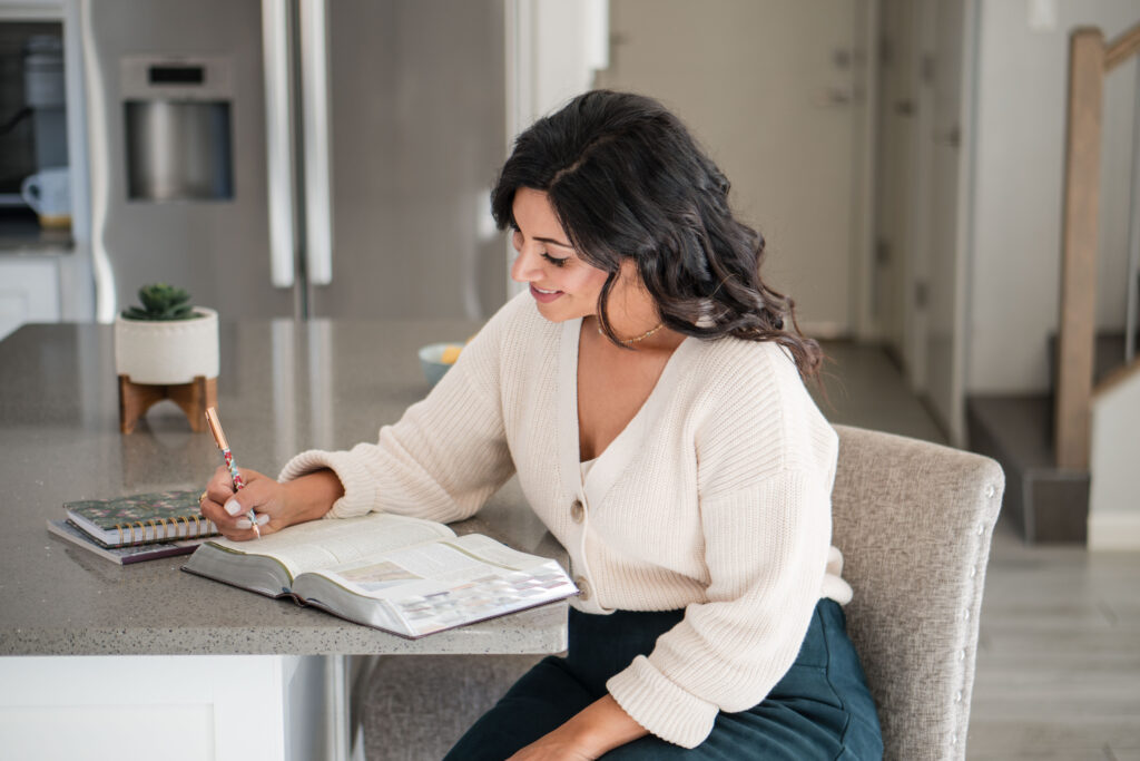 in-kitchen-sitting-at-counter-writing-in-bible-happy-stefanie-gass-horizontal The image title is: Ep-835-How-to-Have-a-Business-Meeting-With-God-Stefanie-Gass